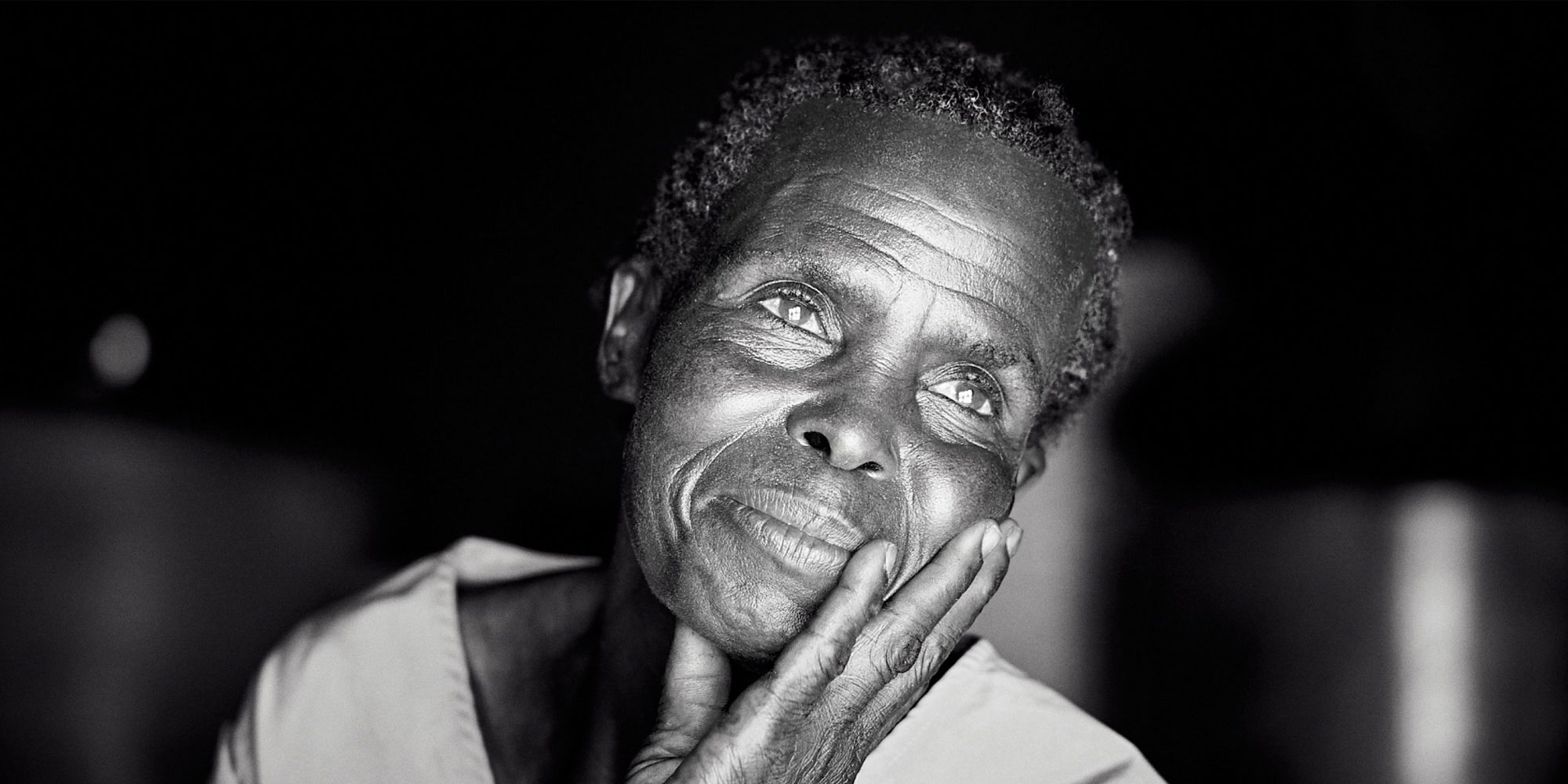 Black and white photo of a thoughtful woman resting her chin on her hand